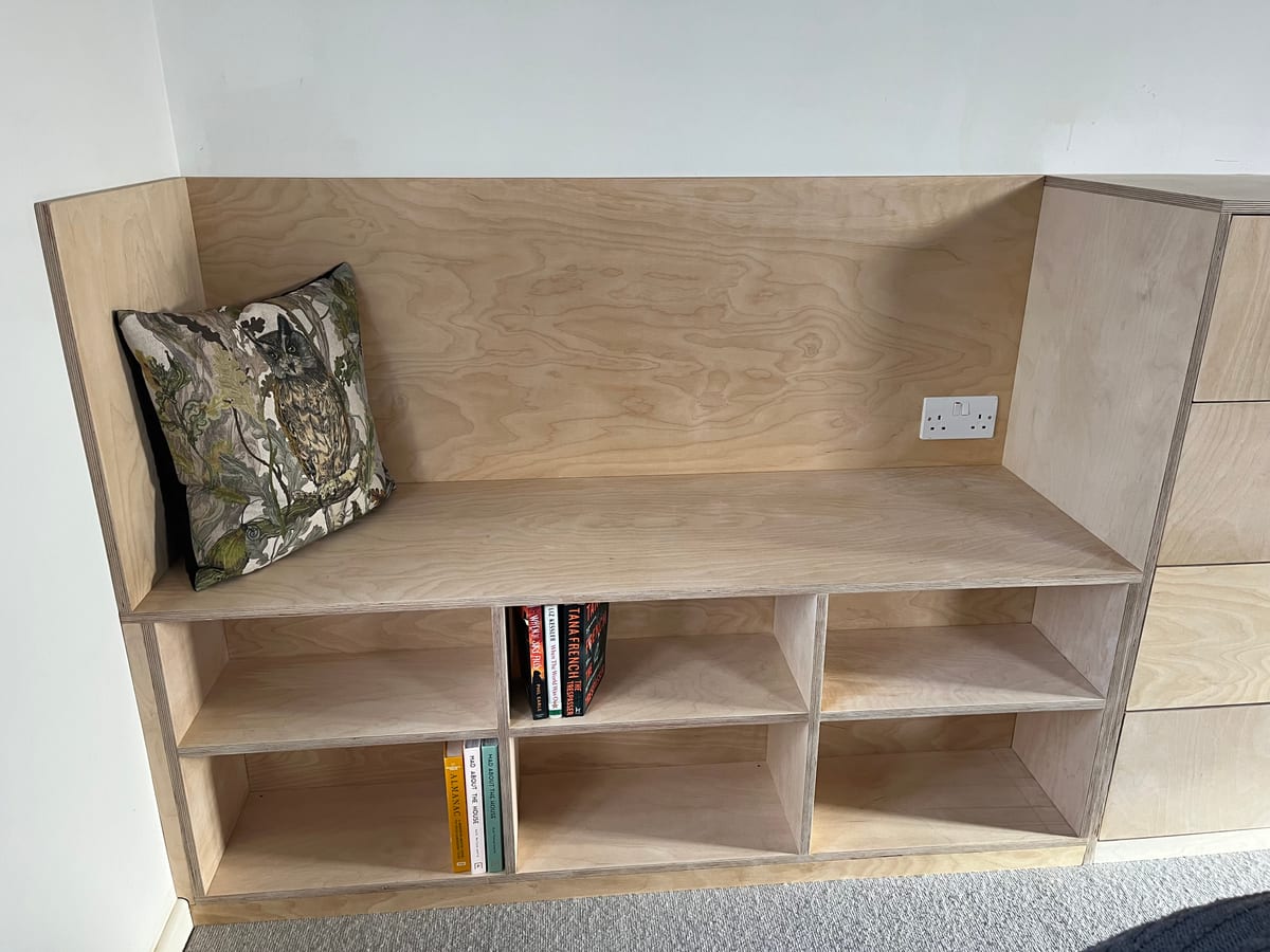 Birch plywood window seat with book storage cubbies beneath