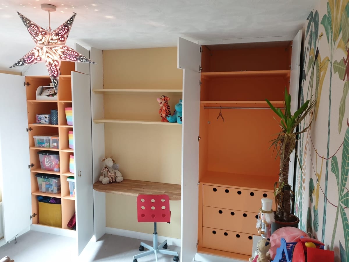 Built-in children's shelving and drawer storage with a fitted desk and wardrobe
